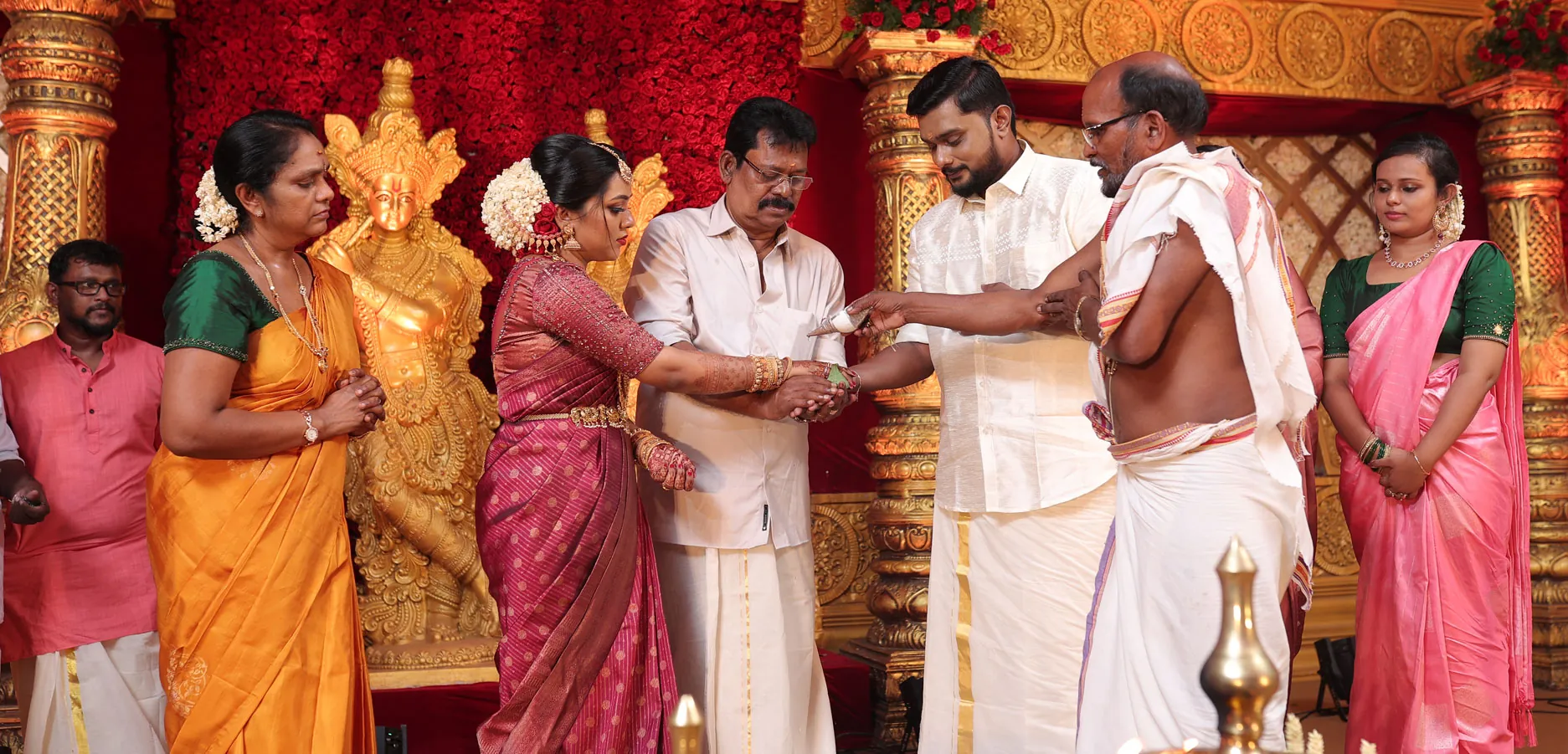 Family gathered with the couple during a Kerala wedding ceremony